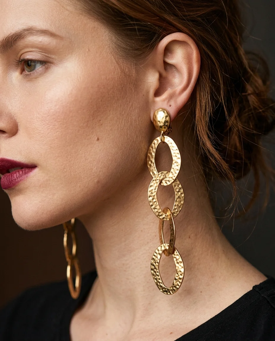 Extreme close-up beauty portrait focusing on the left ear and jawline of a female model with loosely pinned auburn hair...